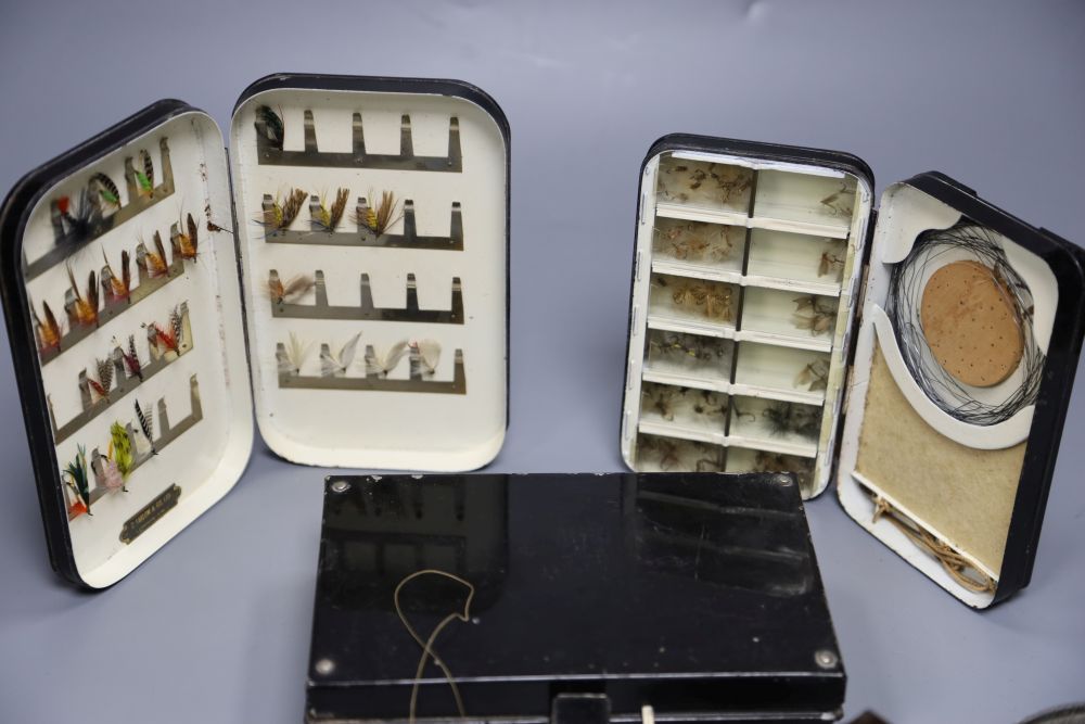 Three early 20th century fly fishing boxes containing flies, lures and line, two by Hardy and Farlow, two reels and a line dryer.